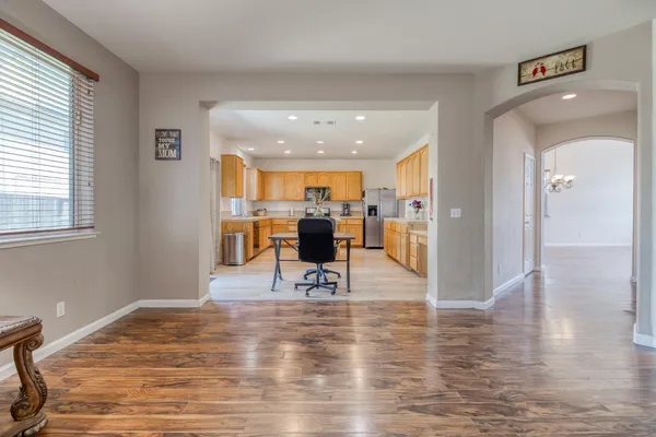 a living room with furniture and a view of kitchen