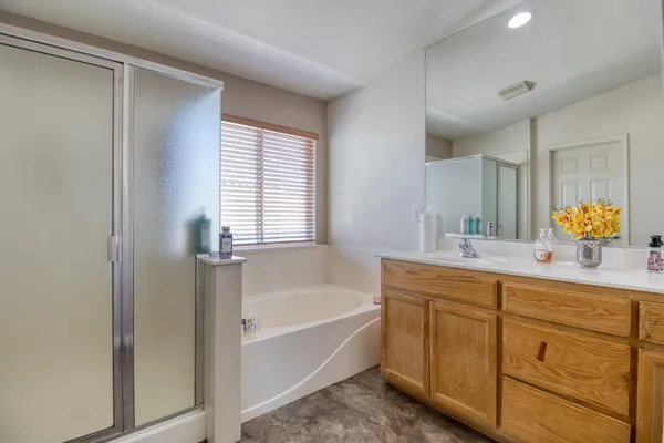 a bathroom with a tub sink and mirror