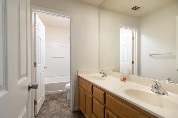 a bathroom with a sink a mirror and a shower