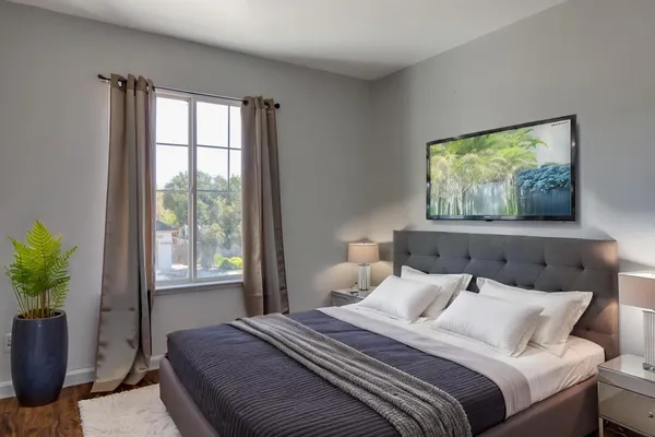 a bedroom with bed and a window