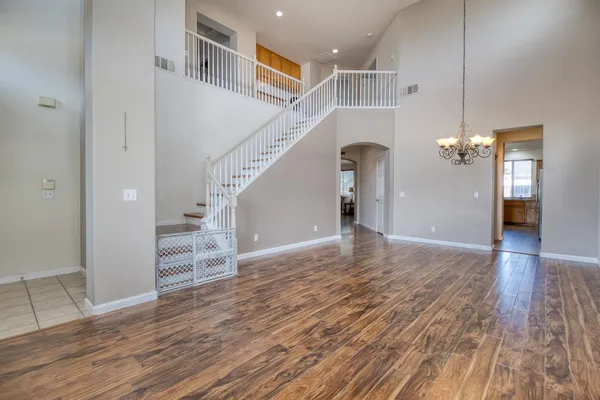 a view of a room with wooden floor and staircase