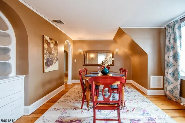 a dining room with furniture and wooden floor