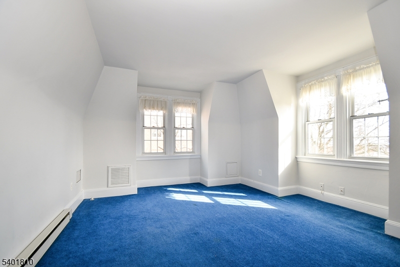 15 Euclid Avenue, Unit 3 Summit, NJ 07901 - Photo 4 of 14 an empty room with wooden floor and windows