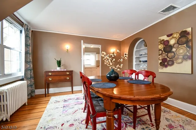 a dining room with furniture and wooden floor