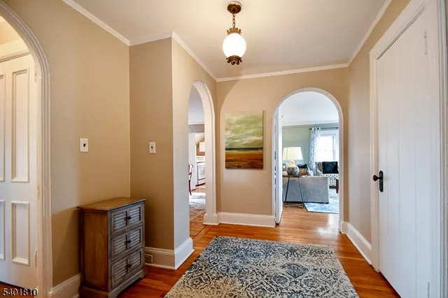 a view of a bedroom with bed and wooden floor