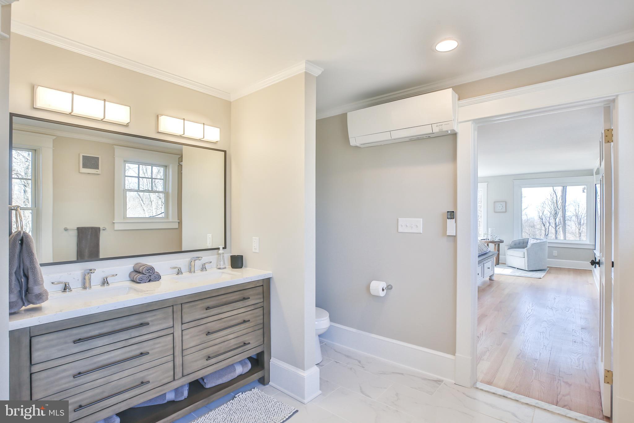 17345 Raven Rocks Road Bluemont, VA 20135 - Photo 46 of 99 a bathroom with a double vanity sink a mirror and a bathtub