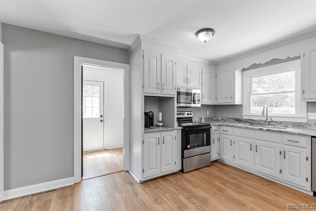 3208 Osborne Road Chester, VA 23831 - Photo 14 of 50 a kitchen with granite countertop white cabinets and stainless steel appliances