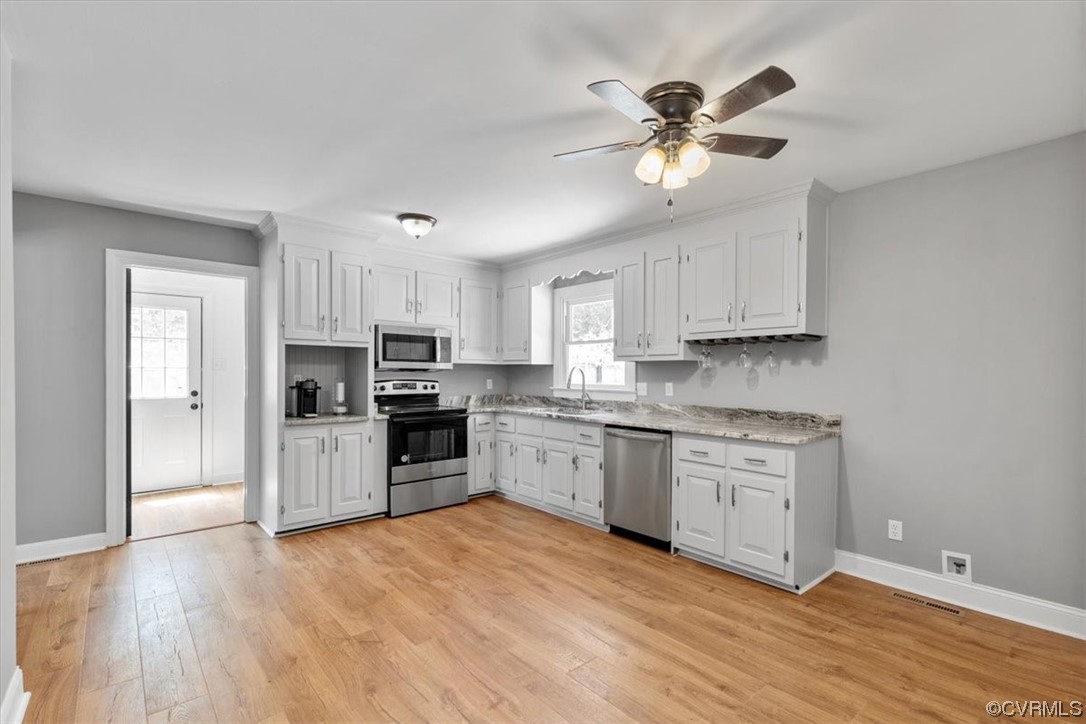 3208 Osborne Road Chester, VA 23831 - Photo 16 of 50 a kitchen with granite countertop a stove a sink dishwasher and a refrigerator with wooden floor
