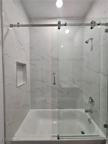 a bathroom with a shower and a bathtub
