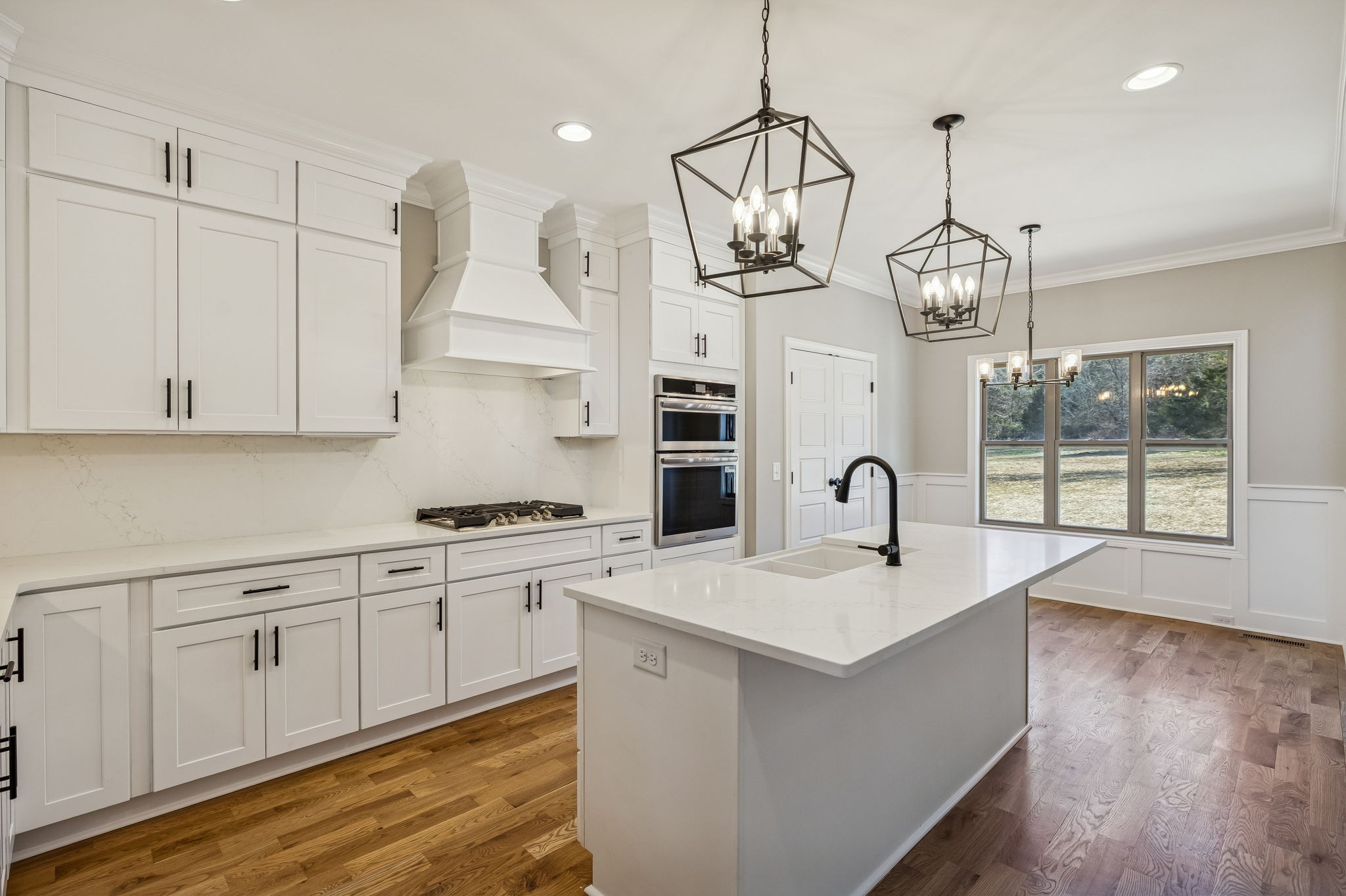 13781 Cainsville Road Lebanon, TN 37090 - Photo 16 of 72 a kitchen with stainless steel appliances granite countertop a stove a sink dishwasher and white cabinets with wooden floor