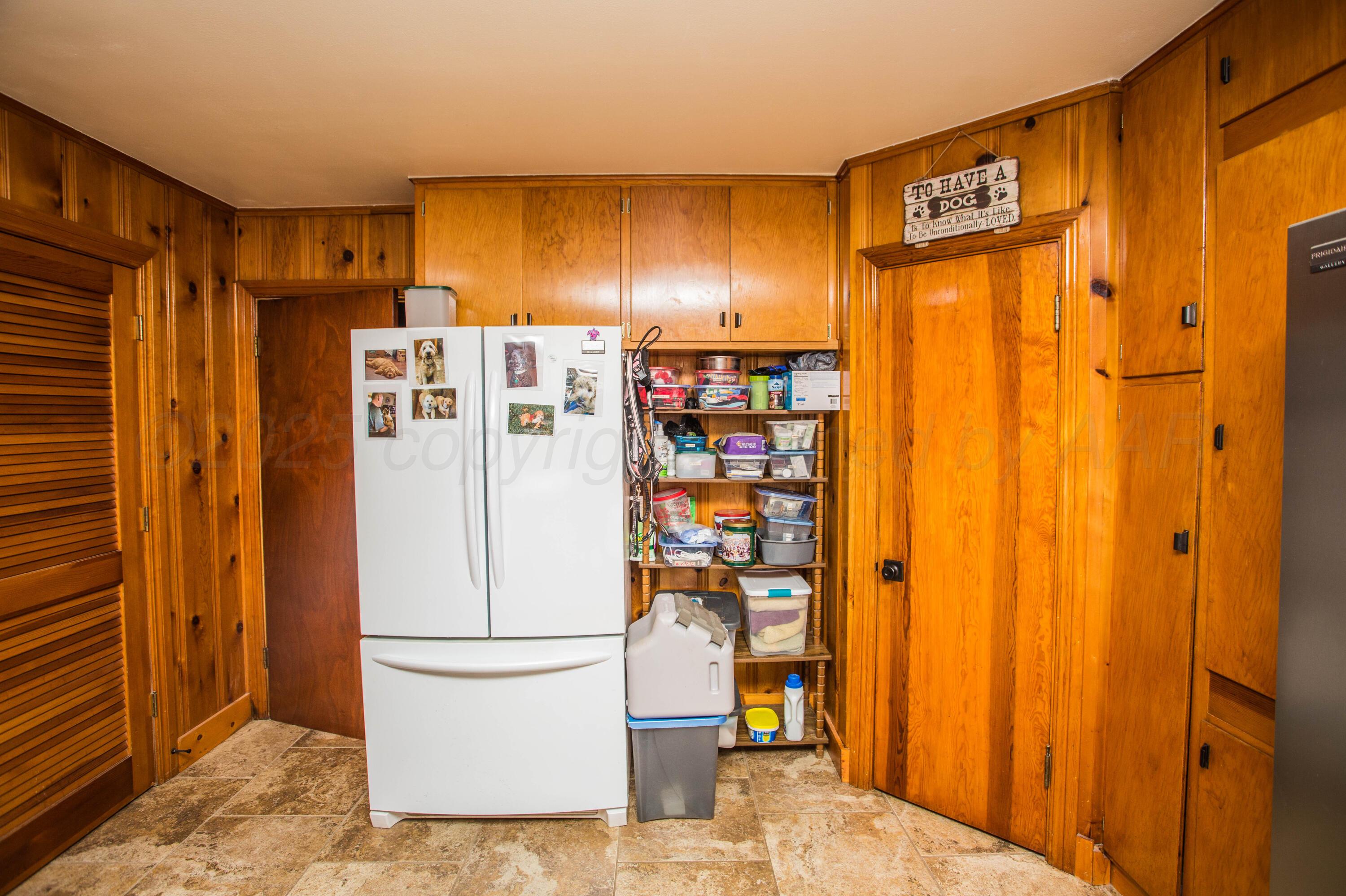 402 Northwest 6th Street Tulia, TX 79088 - Photo 24 of 59 a white refrigerator freezer sitting in a kitchen