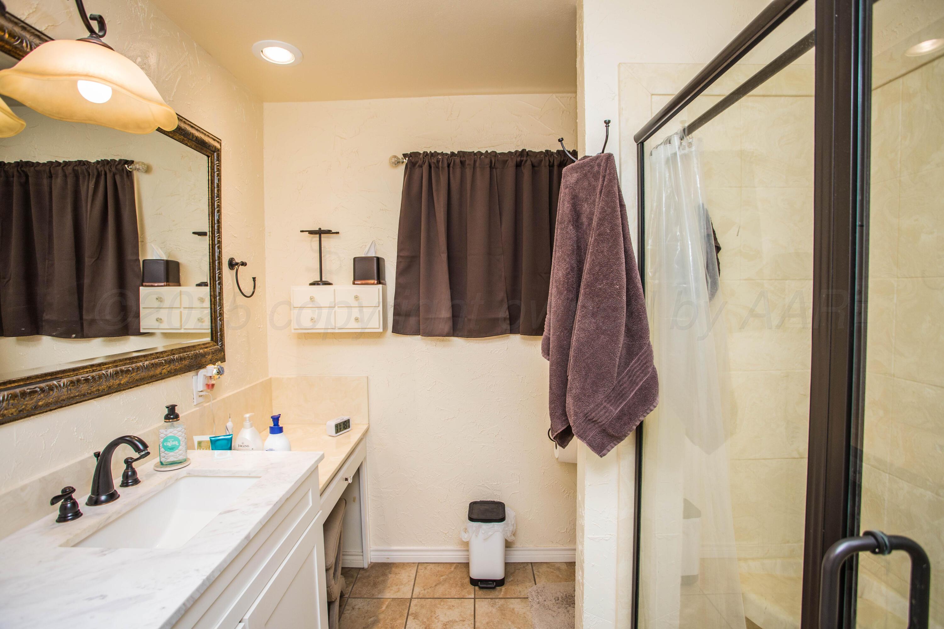 402 Northwest 6th Street Tulia, TX 79088 - Photo 28 of 59 a bathroom with a sink vanity and a mirror
