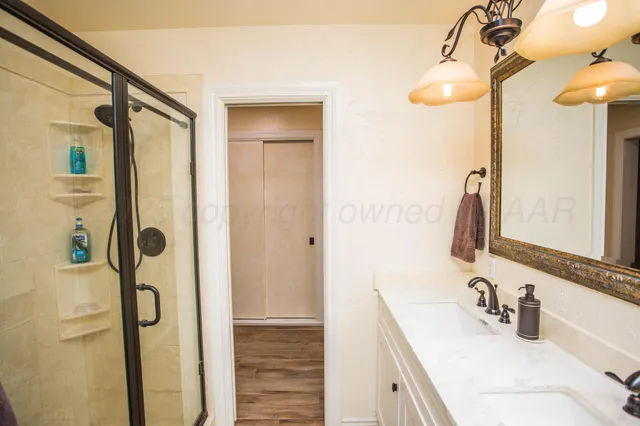 a bathroom with a sink a toilet and shower curtain