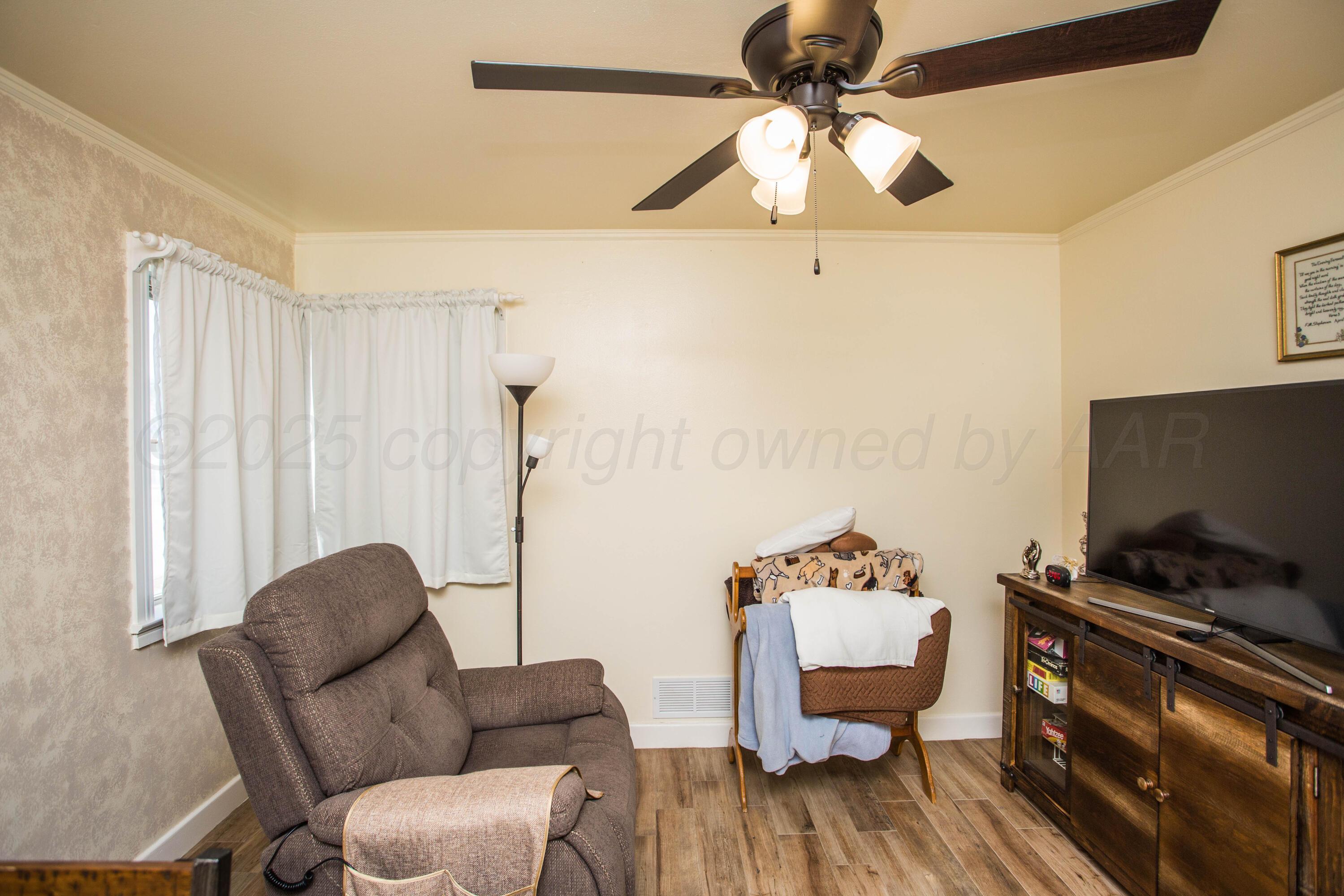 402 Northwest 6th Street Tulia, TX 79088 - Photo 36 of 59 a living room with furniture and a flat screen tv