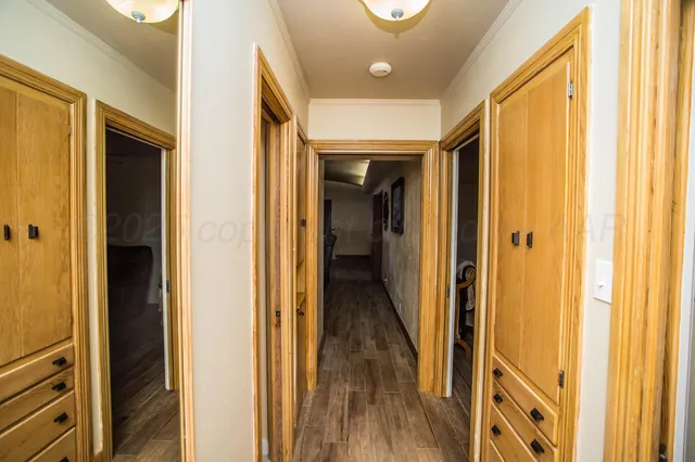 a backyard of a house with trees and covered with wooden fence