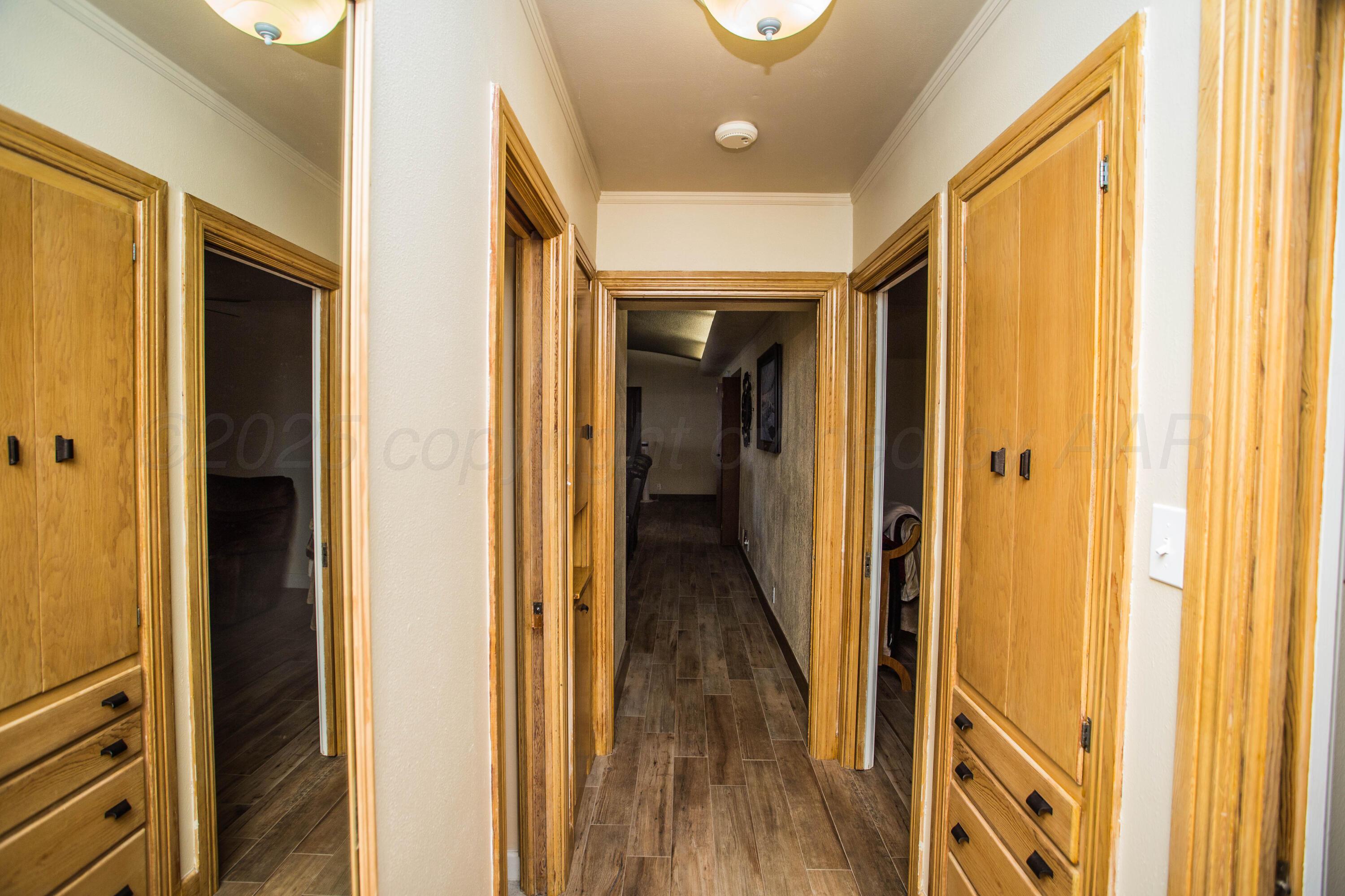 402 Northwest 6th Street Tulia, TX 79088 - Photo 40 of 59 a view of a hallway with wooden floor and staircase