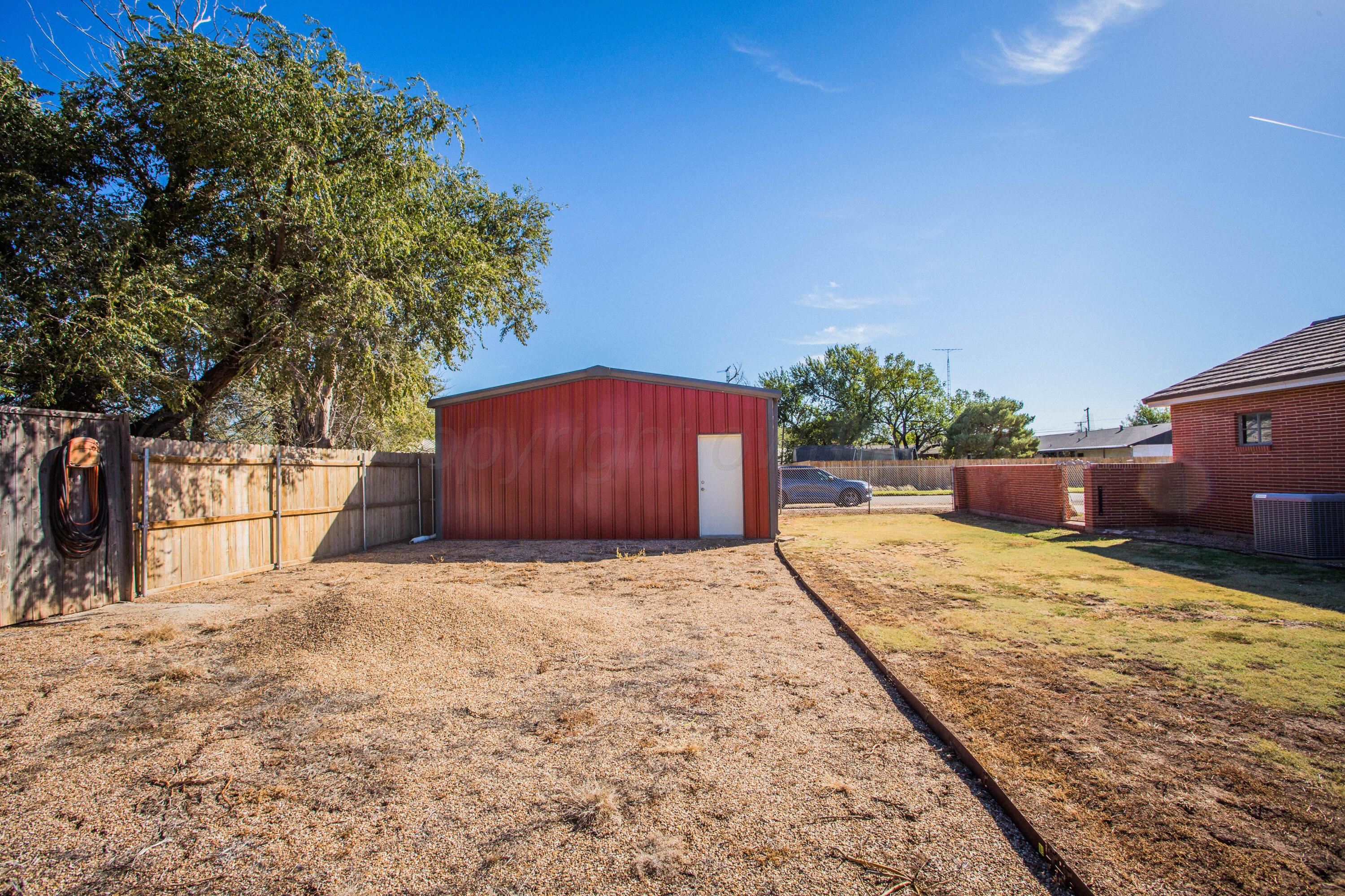 402 Northwest 6th Street Tulia, TX 79088 - Photo 46 of 59 a backyard of a house with trees and covered with wooden fence