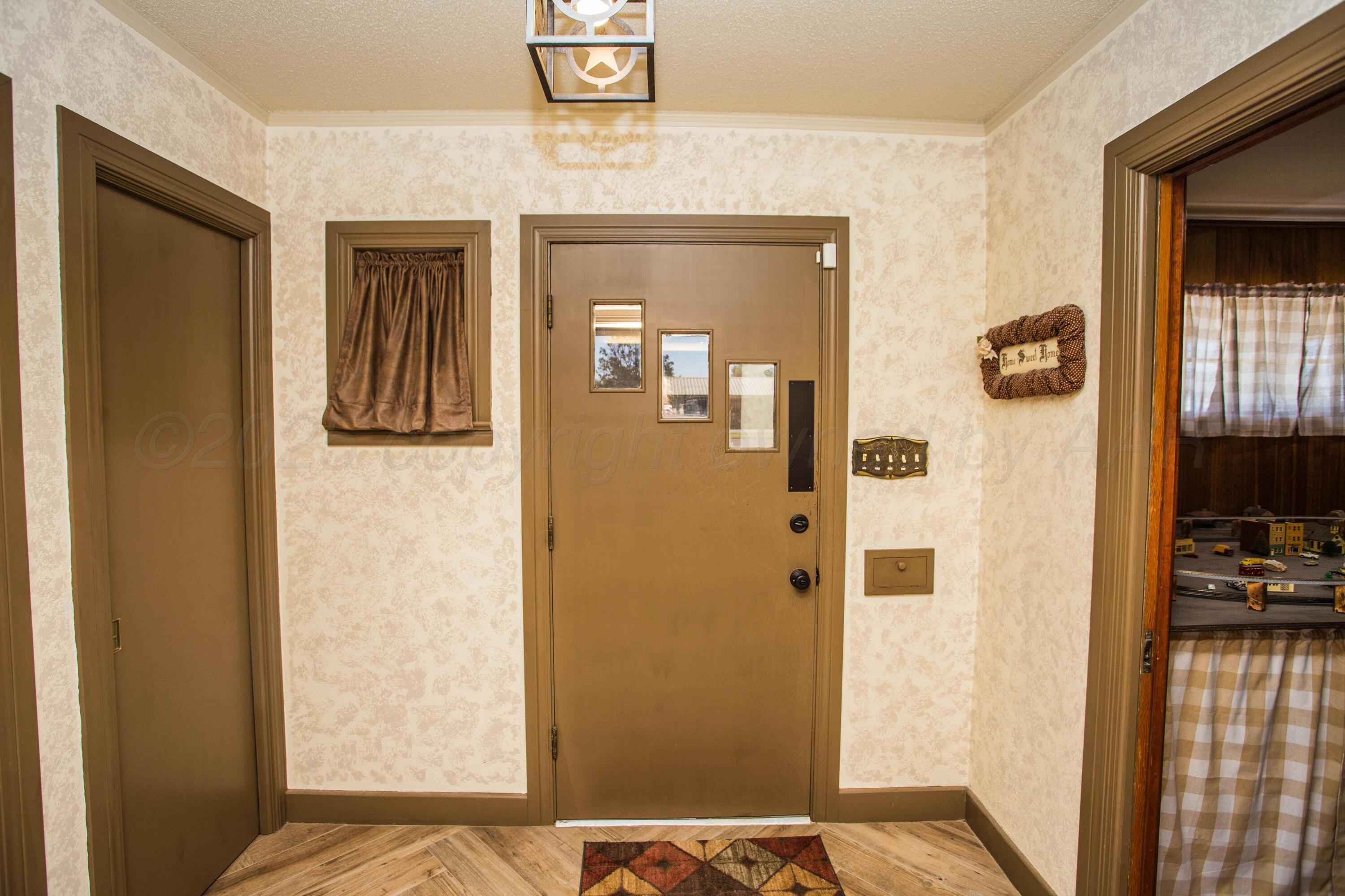 402 Northwest 6th Street Tulia, TX 79088 - Photo 8 of 59 a view of a bedroom from a hallway