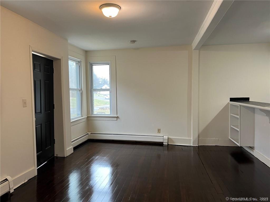85 Prospect Hill Road, Unit 7 New Milford, CT 06776 - Photo 2 of 8 an empty room with wooden floor and windows