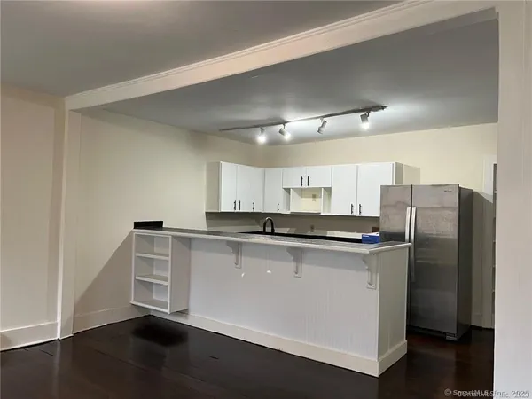 a kitchen with stainless steel appliances a refrigerator and a stove