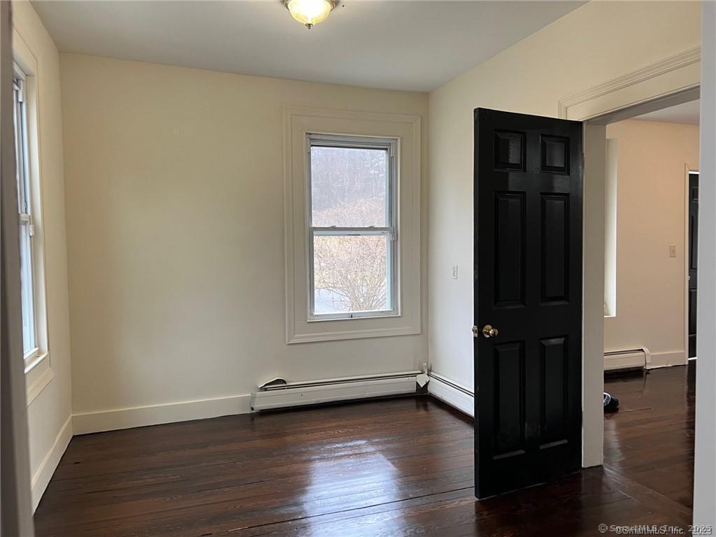 85 Prospect Hill Road, Unit 7 New Milford, CT 06776 - Photo 5 of 8 an empty room with wooden floor and closet
