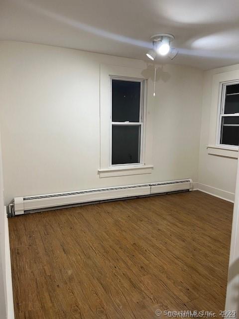 85 Prospect Hill Road, Unit 7 New Milford, CT 06776 - Photo 7 of 8 an empty room with wooden floor and windows