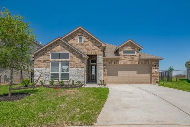 a front view of a house with a yard and garage
