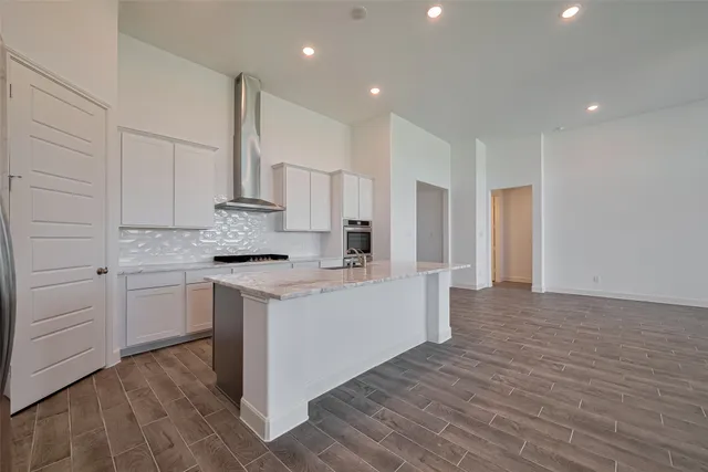a kitchen with white cabinets appliances and sink