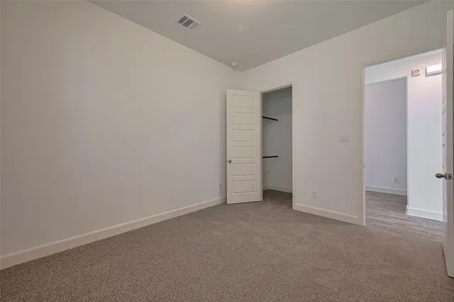 an empty room with closet area