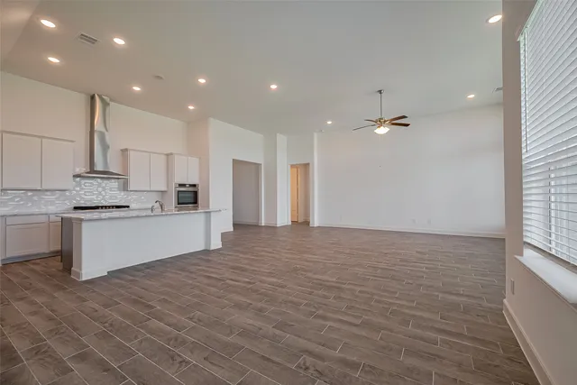 a large kitchen with kitchen island a sink stainless steel appliances and cabinets