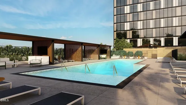 a swimming pool with outdoor seating and yard