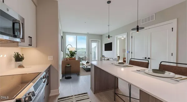 a kitchen that has a lot of cabinets a sink and appliances