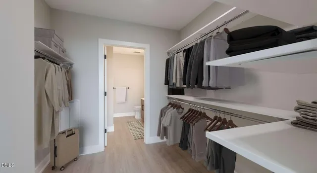a bathroom with a sink toilet double vanity and shower