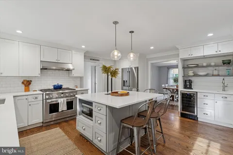 a spacious bedroom with a bed and wooden floor