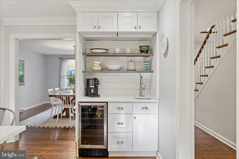 a spacious bathroom with a granite countertop sink a mirror a bathtub and shower