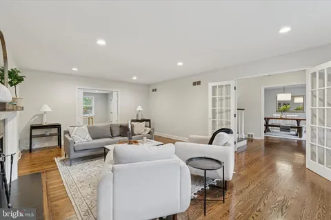 a dining room with furniture a rug and a mirror