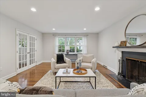 a kitchen with stainless steel appliances granite countertop a dining table chairs stove refrigerator and cabinets