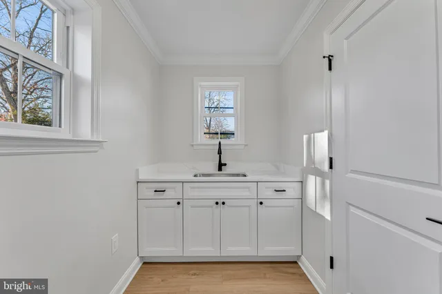 a view of a kitchen with sink and window