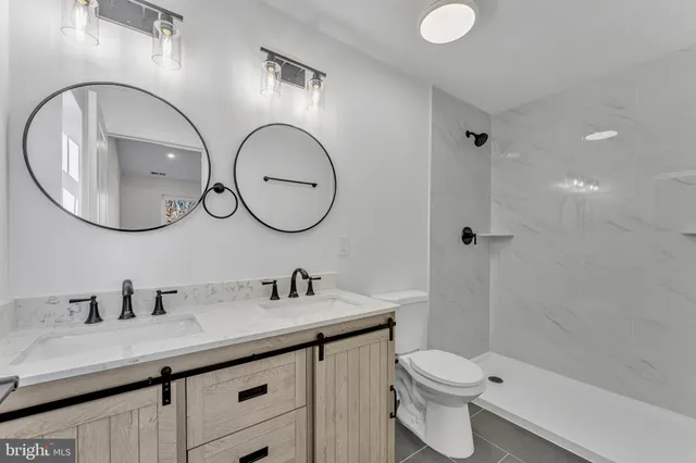 a bathroom with a toilet a sink and mirror