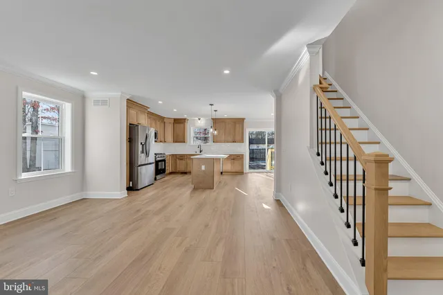 a view of a kitchen with furniture and wooden floor