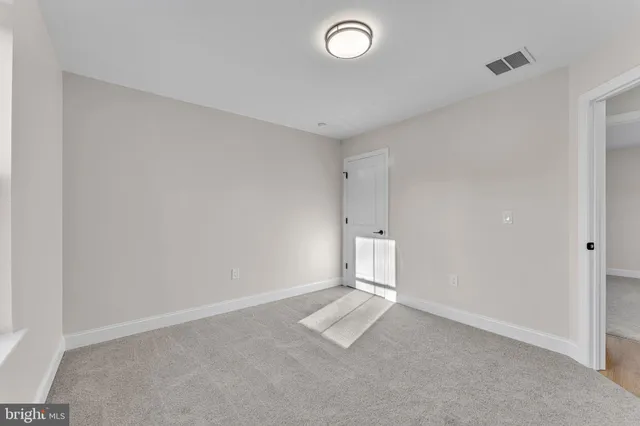 an empty room with a empty space and windows