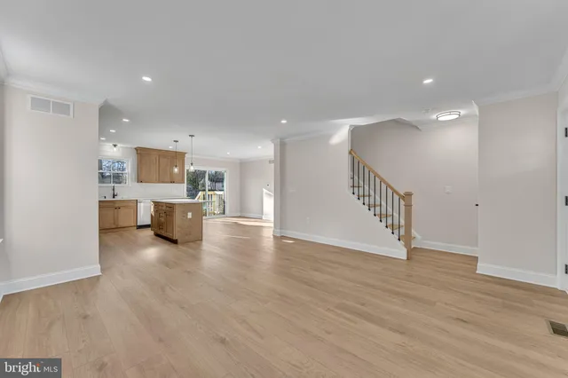 a view of a kitchen with wooden floor and a sink