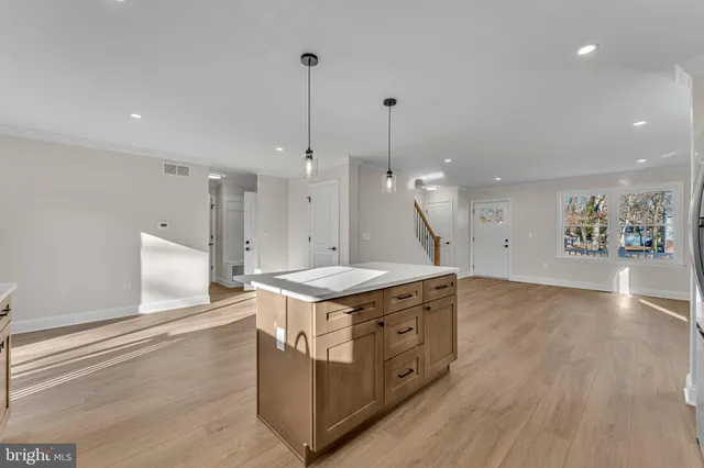 a kitchen with stainless steel appliances granite countertop a stove and a wooden floors