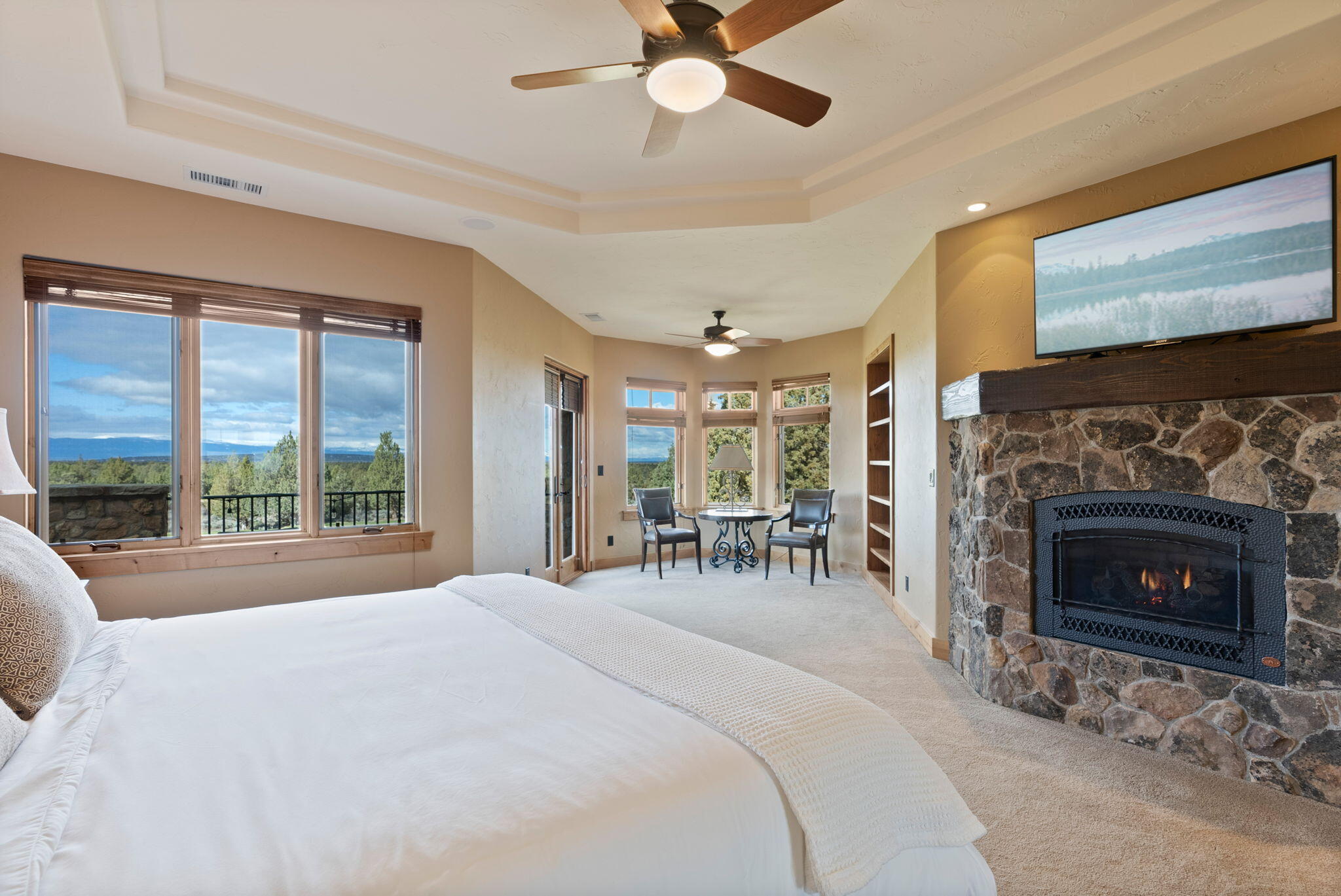 22887 Ghost Tree Lane Bend, OR 97701 - Photo 45 of 97 The stunning primary suite boasts a fireplace, sitting area, coffee bar, spa-like bath, private balcony & expansive views.