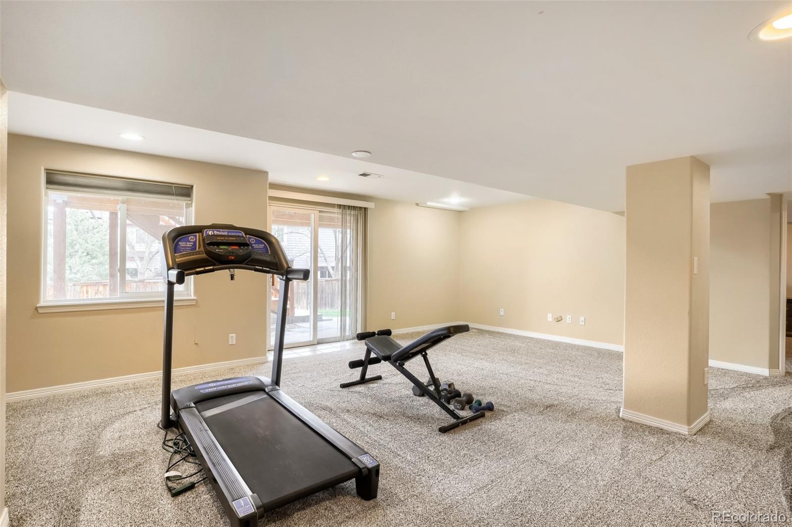 25 Estack Place Highlands Ranch, CO 80126 - Photo 13 of 28 a room with gym equipment and a window