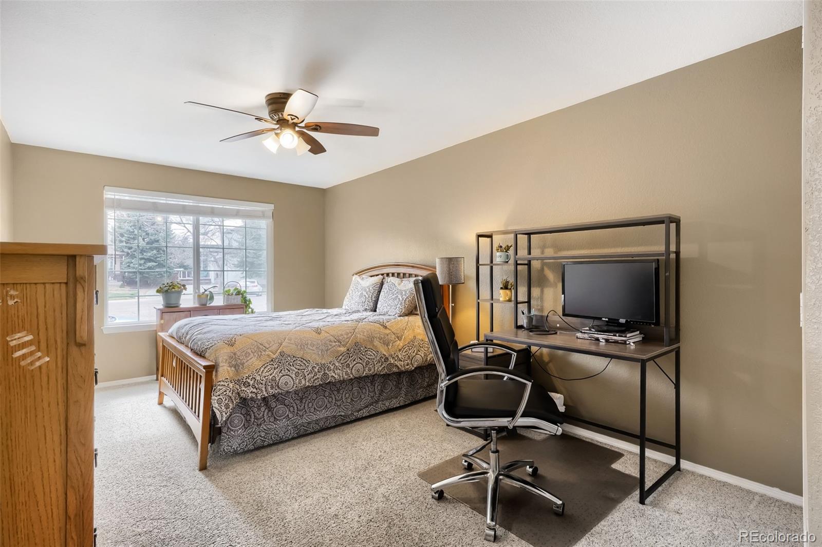 25 Estack Place Highlands Ranch, CO 80126 - Photo 17 of 28 a bedroom with a bed and a desk