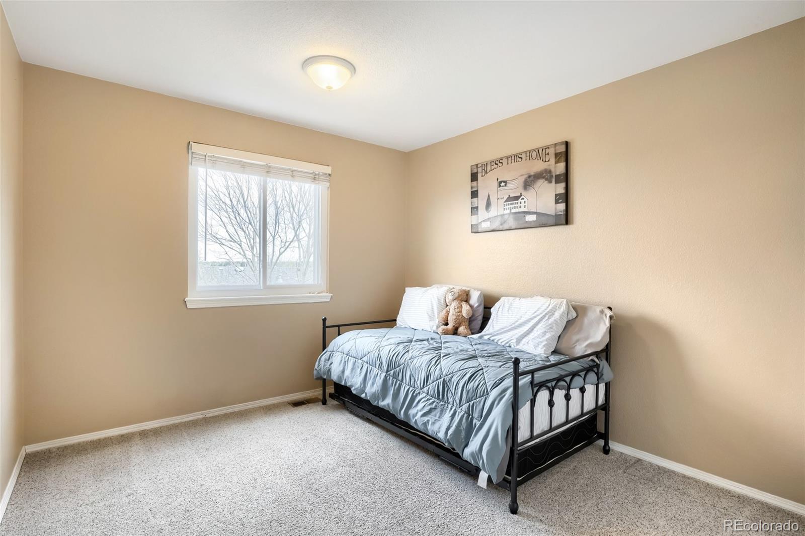 25 Estack Place Highlands Ranch, CO 80126 - Photo 18 of 28 a bedroom with a bed and window