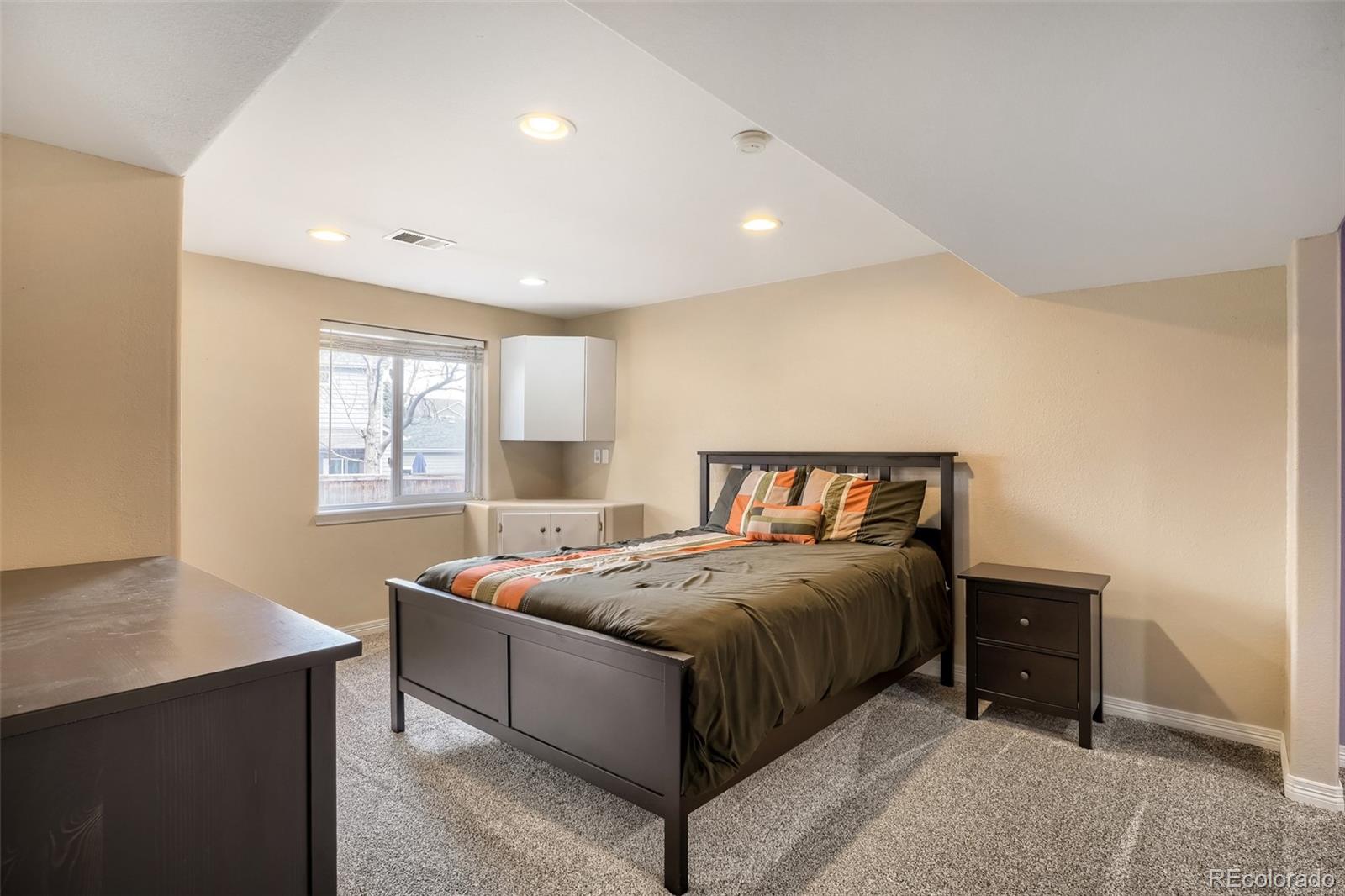 25 Estack Place Highlands Ranch, CO 80126 - Photo 21 of 28 a bedroom with a bed and window