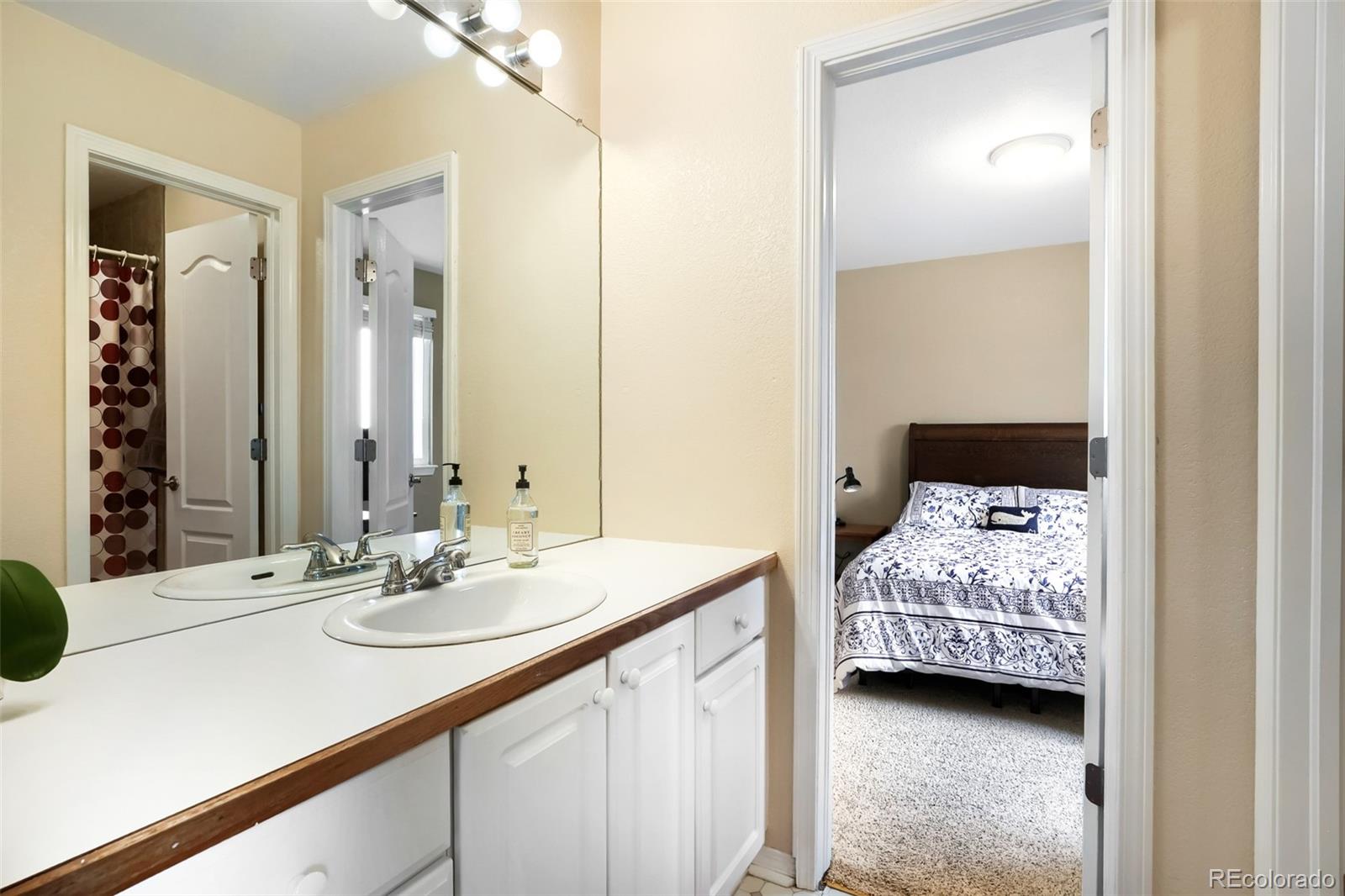 25 Estack Place Highlands Ranch, CO 80126 - Photo 22 of 28 a en suite bathroom with a sink double vanity and a mirror