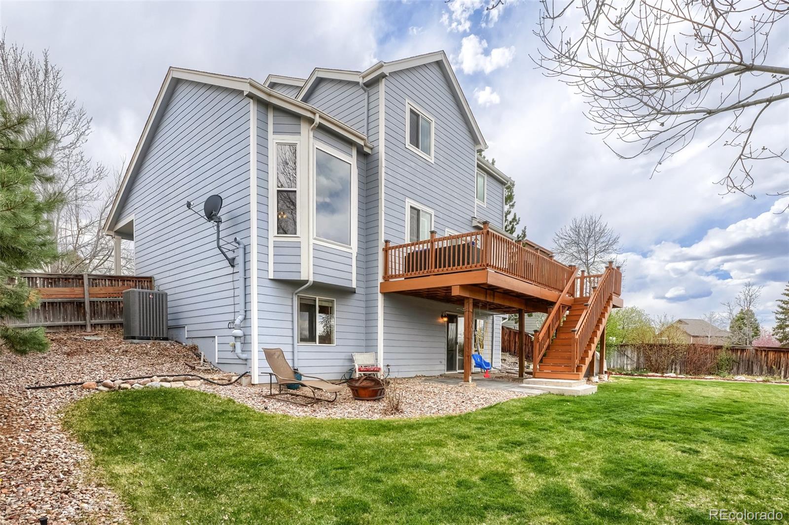 25 Estack Place Highlands Ranch, CO 80126 - Photo 27 of 28 a view of a house with a yard porch and sitting area